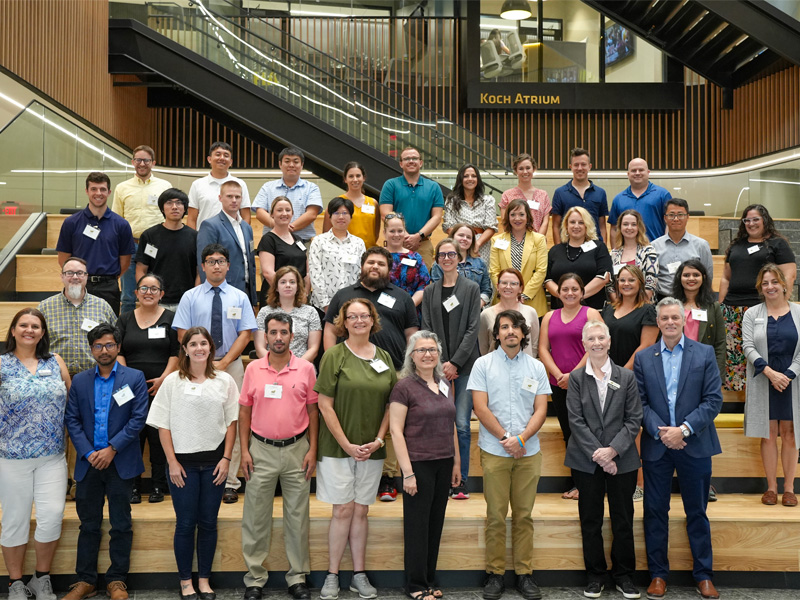 Wichita State University's new faculty for fall 2024 pose with President Rick Muma