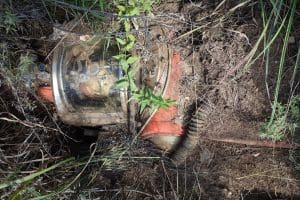 A sculpture of an imaginary astronaut is burried in the ground.