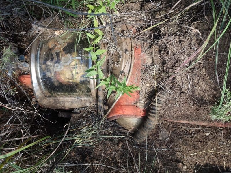 A sculpture of an imaginary astronaut is burried in the ground.