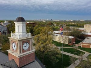 Drone shot of campus with the Morrison Hall clock tower in view