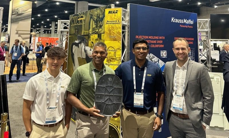 Jerome Teoh, Waruna Seneviratne, Induwara Herath (NIAR) and a representative from KrausMaffei with a prototype from the award-winning project at CAMX.