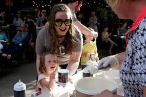 Mother and daughter wait with their KMUW for an ice cream scoop.