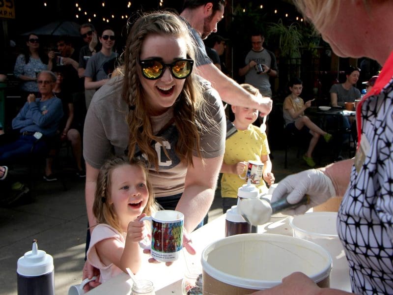 Mother and daughter wait with their KMUW for an ice cream scoop.