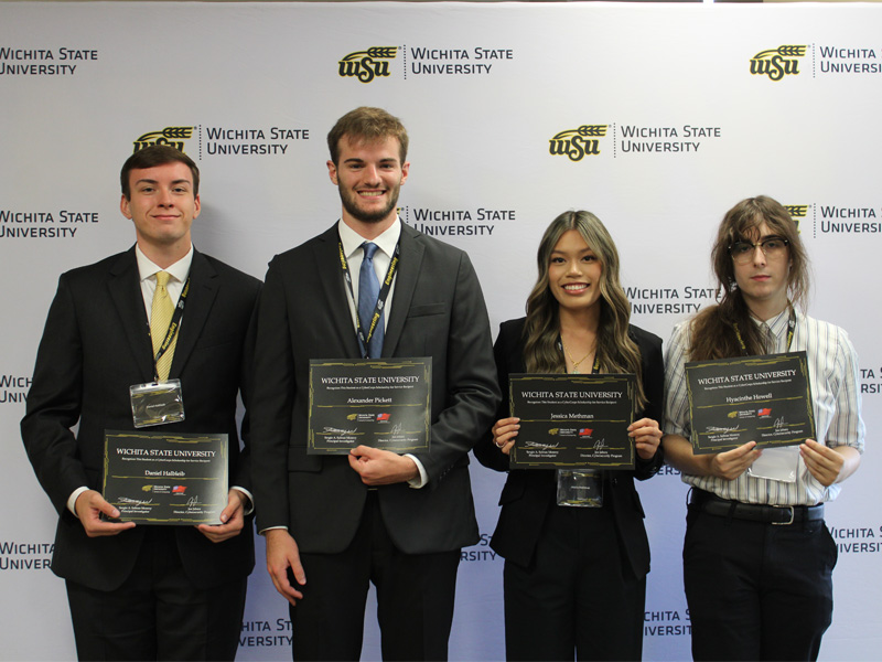 Daniel Halbeib, Alexander Pickett, Jessica Methman and Hyacinthe Howell pose with their scholarship diplomas