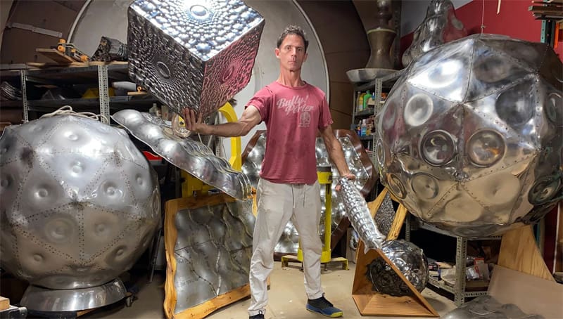 Eric Schmidt poses with his metal sculptures.