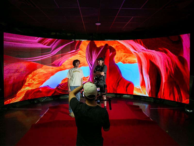 A production films at the Synthetic Scenes digital wall