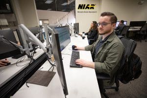 Wichita State University students work at desktop computers in NIAR's Aircraft Structural Test & Evaluation Center.