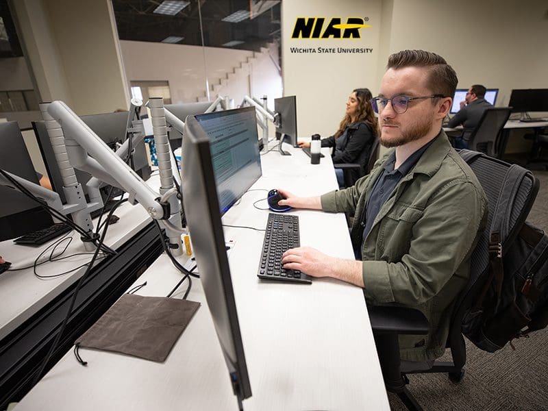 Wichita State University students work at desktop computers in NIAR's Aircraft Structural Test & Evaluation Center.