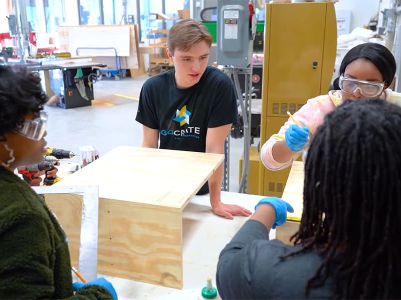 GoCreate technician Ryan Holle works with community members to build and personalize Little Free Libraries for installation across the city.