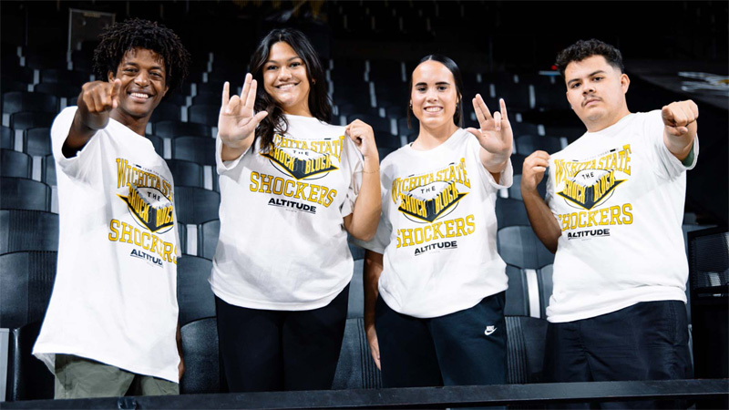 Students showcase the t-shirt that is being given away in the student section at Koch Arena