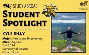 Photo of Kyle Shay on the mountains with his arms open wide. Information about Kyle Shay is included. His major is aerospace engineering and his minor is in Spanish. He studied abroad fall 2024 at the University of Deusto in Bilbao, Spain.