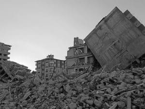 Image shows several collapsed houses, which was captured in August 2023, more than six months after two earthquakes obliterated much of Antakya, Turkey