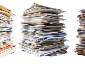 This is a tall stack of papers organized haphazardly.