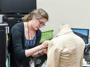Melissa Penkava Koza works on a costume for Music Theatre Wichita