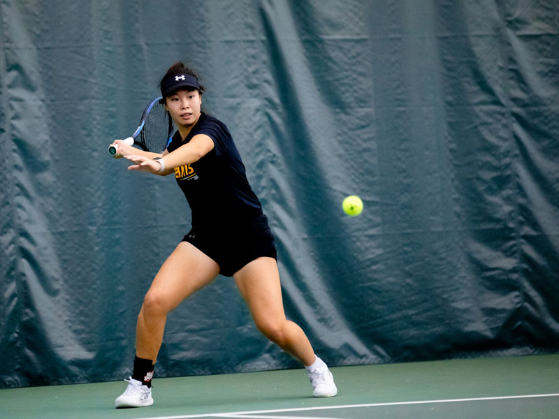 Xin Tong Wang prepares to hit a tennis pall served from the other player