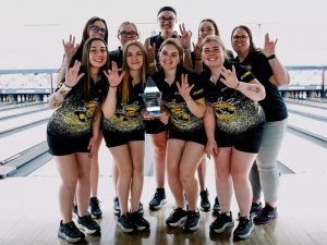 Shocker women's bowling team holds up their trophy from the Mid-Winter Invitational
