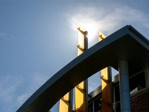 The sun peeks through the roof of the Rhatigan Student Center