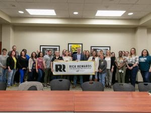 President Rick Muma and WuShock pose with the staff in the Office of Human Resources for Rick Rewards