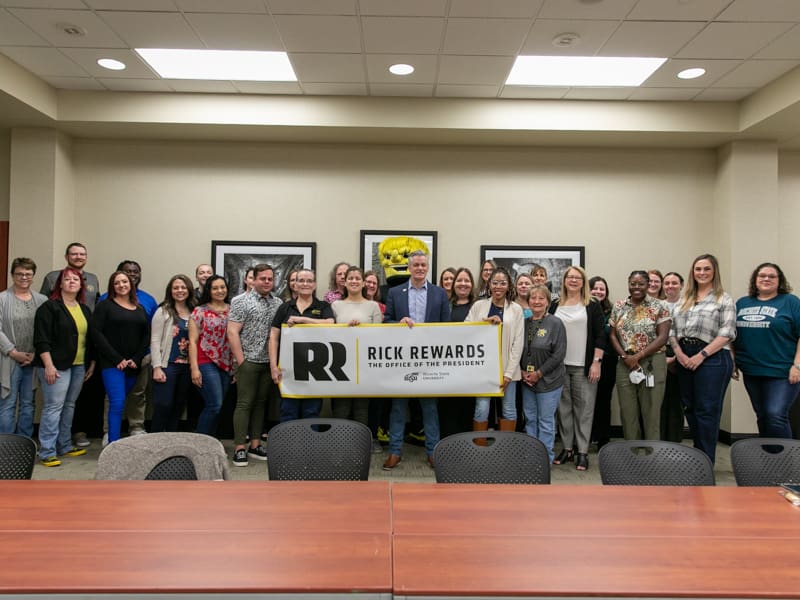 President Rick Muma and WuShock pose with the staff in the Office of Human Resources for Rick Rewards