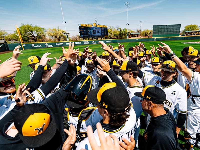 Shocker Baseball gathers in a team huddle after a win