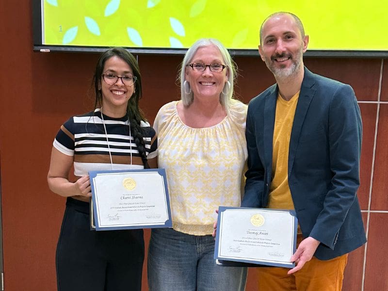 Charvi Sharma (Master's Student in Exercise Science, 1st place), Dr. Heidi Bell (HPS Department Chair, PI and Advisor) and Toomaj Amiri (Master's student in Innovation and Design, 2nd place).
