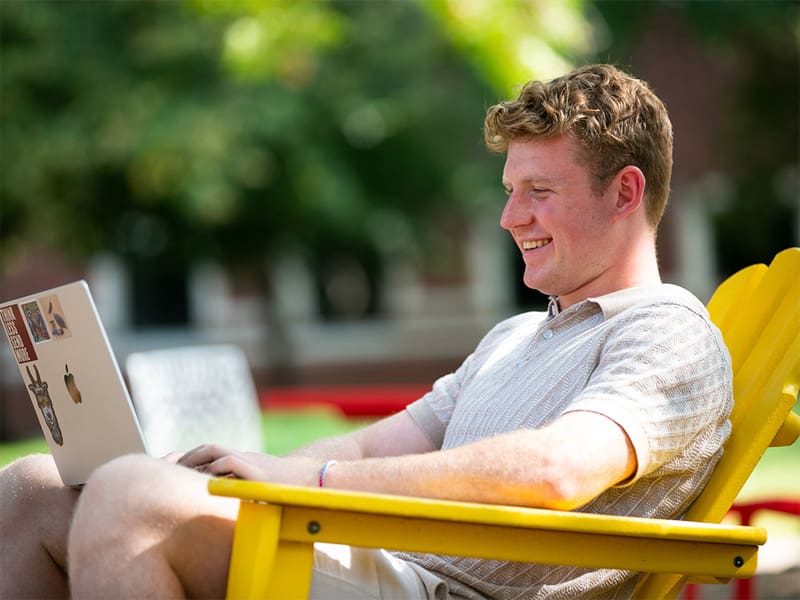 Adam Key works on a class assignment outside on Wichita State's campus