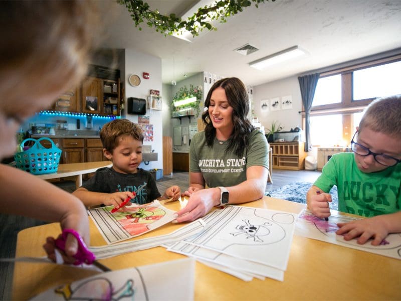 Ashlyn Riggs working with kids in the Child Development Center