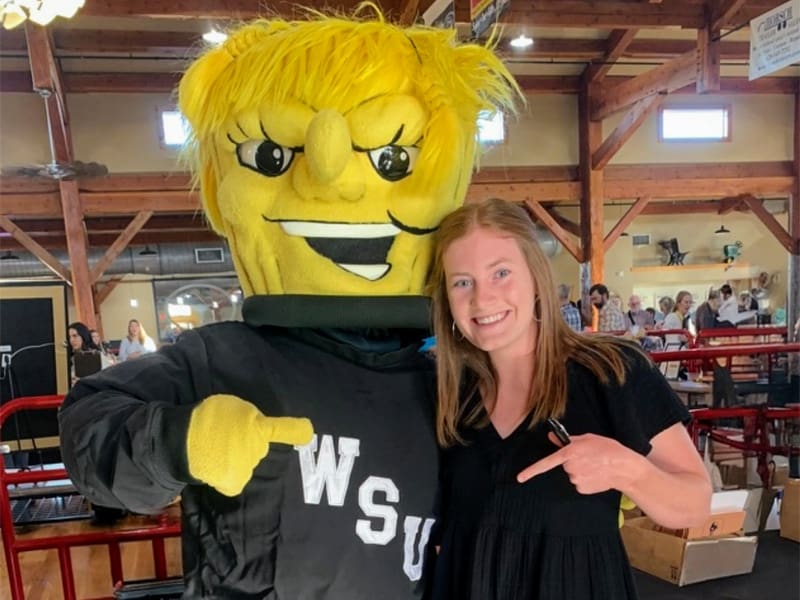 Lindsey Mendenhall poses with WuShock at an event