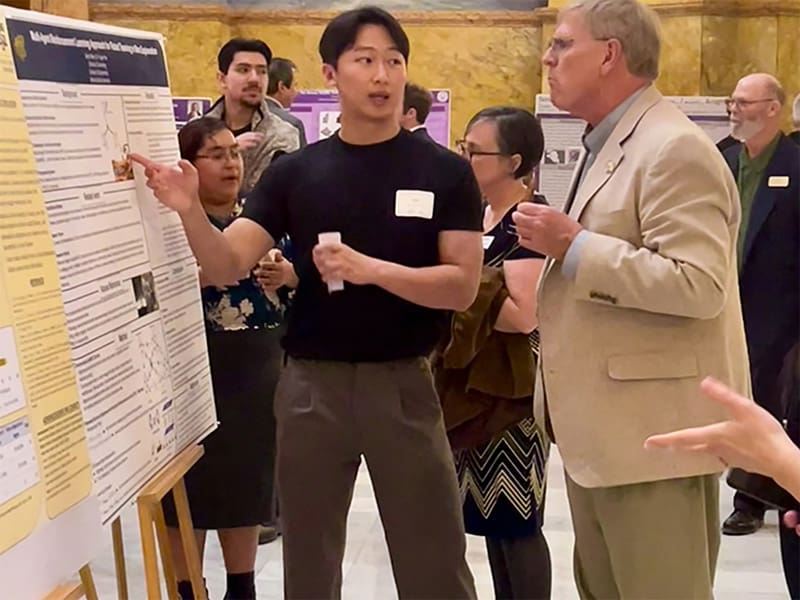 Sejun Moon presents his work to attendees at the Kansas Capitol in Topeka in February.