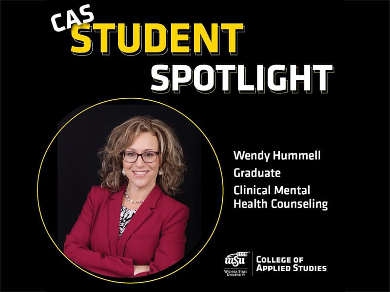A graphic titled CAS Student Spotlight features a professional headshot of Wendy Hummell, a graduate student in Clinical Mental Health Counseling at Wichita State University. Wendy is wearing a maroon blazer, glasses, and a confident smile. Her image is framed in a circular border with a black background and yellow outline. The Wichita State University logo and College of Applied Studies branding appear in the lower right corner.