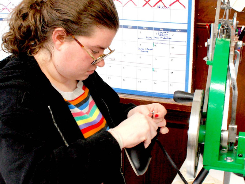 Mia Dennett, a junior from Salina, works on costume for a show