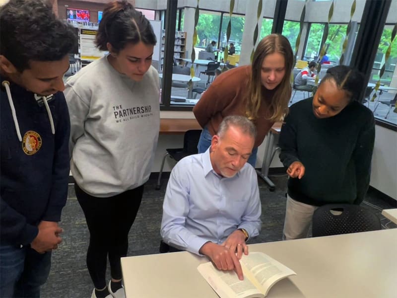 Michael Birzer works with several students in the Undergraduate Research and Creative Activity Hub