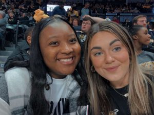 Tayana Martin enjoys a Shocker basketball game with a friend.