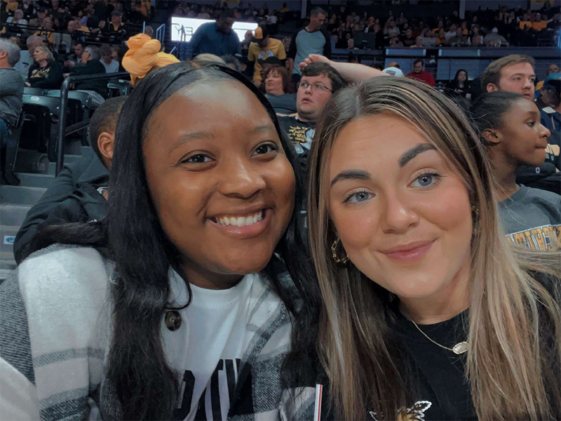 Tayana Martin enjoys a Shocker basketball game with a friend.