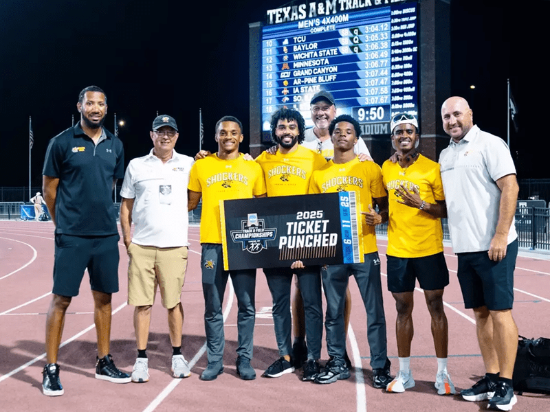 Members of the men's track team hold up a sign that says "2025 ticket punched"