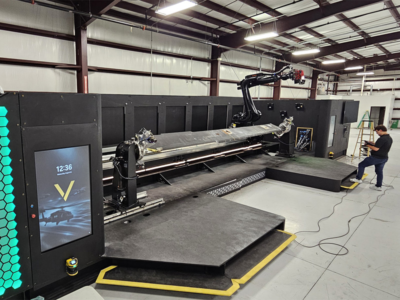 A person works on the new VISION repair robot
