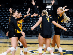 The Shocker volleyball team celebrate after winning a game in Charles Koch Arena