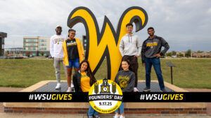 Founders' Day of Giving Logo sits in front of a group of smiling WSU students.