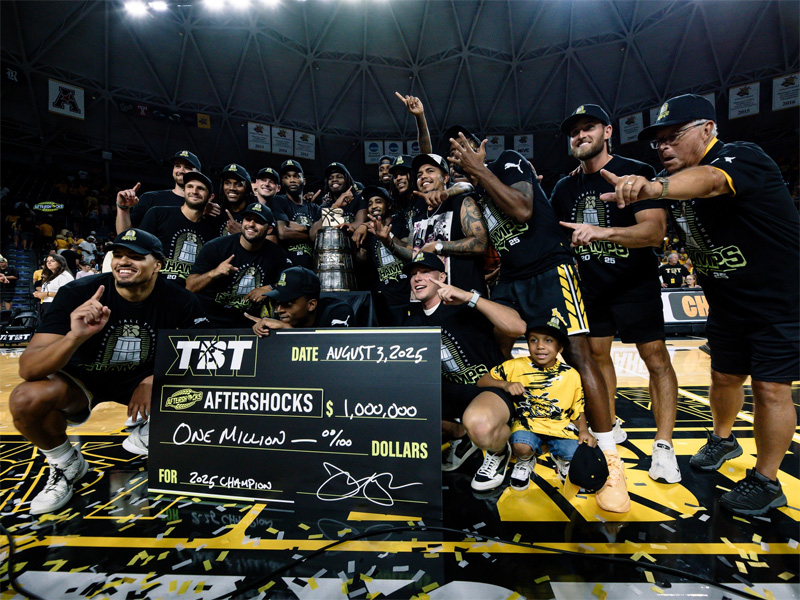 The AfterShocks team poses with its $1 million check after winning The Basketball Tournament in Charles Koch Arena
