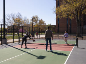 Students playing pickleball on the campus courts