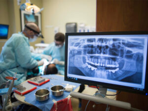 WSU General Dentistry dentists work on a student in their office.