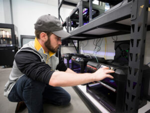 A student works on a project on one of GoCreate's 3D printers