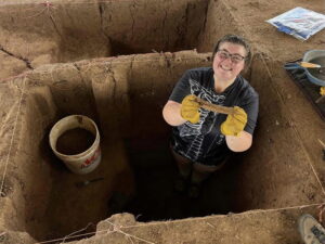 Lucy Walters holds a bone she found while excavating at the Etzanoa site