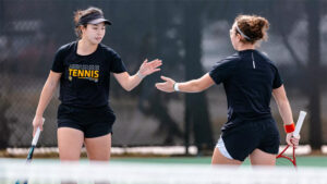 Xin Tong Wang and Giorgia Roselli celebrate at a game for Wichita State