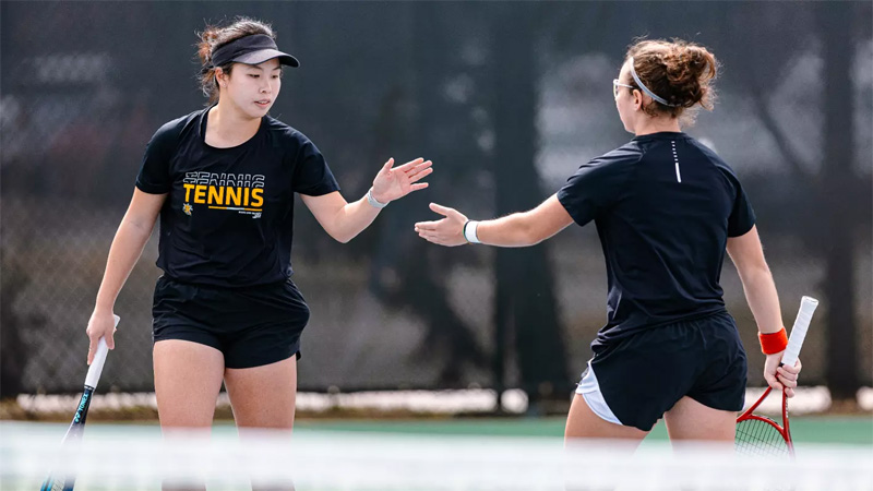 Xin Tong Wang and Giorgia Roselli celebrate at a game for Wichita State