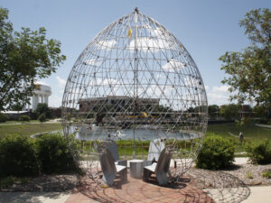 The Love Locks pod on campus with the Promise Bridge and NIAR in the background