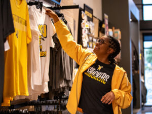 A student picks out Shocker gear at the Shocker Store at Braeburn Square