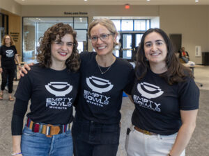Brenda Lichman poses with to other woman during an Empty Bowls Wichita event.