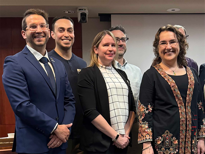 Christopher Leonard, Marco Hernandez, Erin O'Bryan and Lisa Parcell being recognized for their Faculty and Staff of the Year Award