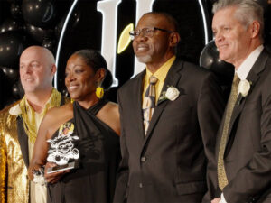 Administrators at Wichita State stand with the parents of Kiah Duggins as she is posthumously awarded the 2025 Young Alumni Award